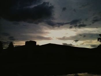 Built structures against cloudy sky