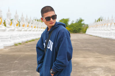 Portrait of a handsome young man standing outdoors