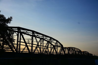 Low angle view of silhouette bridge against sky during sunset