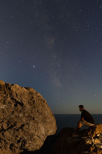 Scenic view of rocks against sky at night