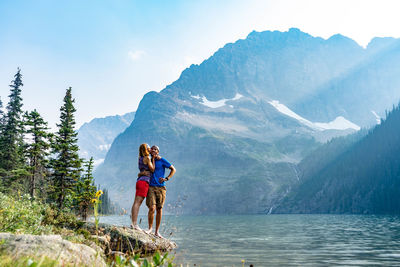 Woman on lake against mountain range