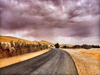 Empty road along countryside landscape