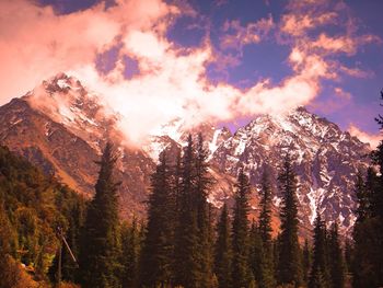 Scenic view of mountains against cloudy sky