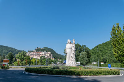 Statue of plants against blue sky