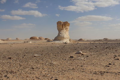 Stone wall on desert against sky
