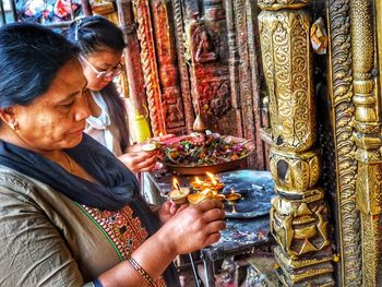 Midsection of woman sitting in temple