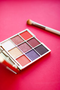 High angle view of beauty products on red background