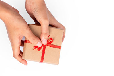 Midsection of person holding paper against white background