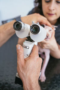 Midsection of woman holding camera