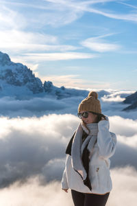 Portrait of woman in front of amazing alpine landscape with snow capped mountains