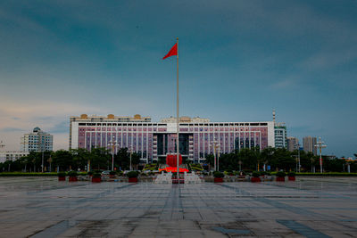 Red flags against buildings in city