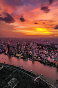 High angle view of buildings against cloudy sky during sunset