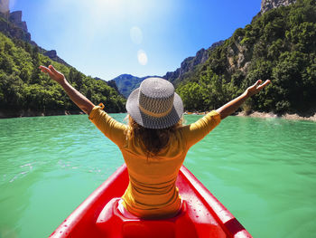 Rear view of woman with hat in water