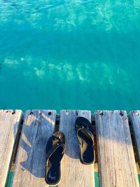 High angle view of slippers on pier over sea