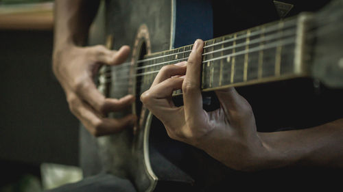 Hands playing guitar