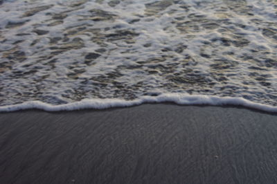 High angle view of waves rushing towards shore