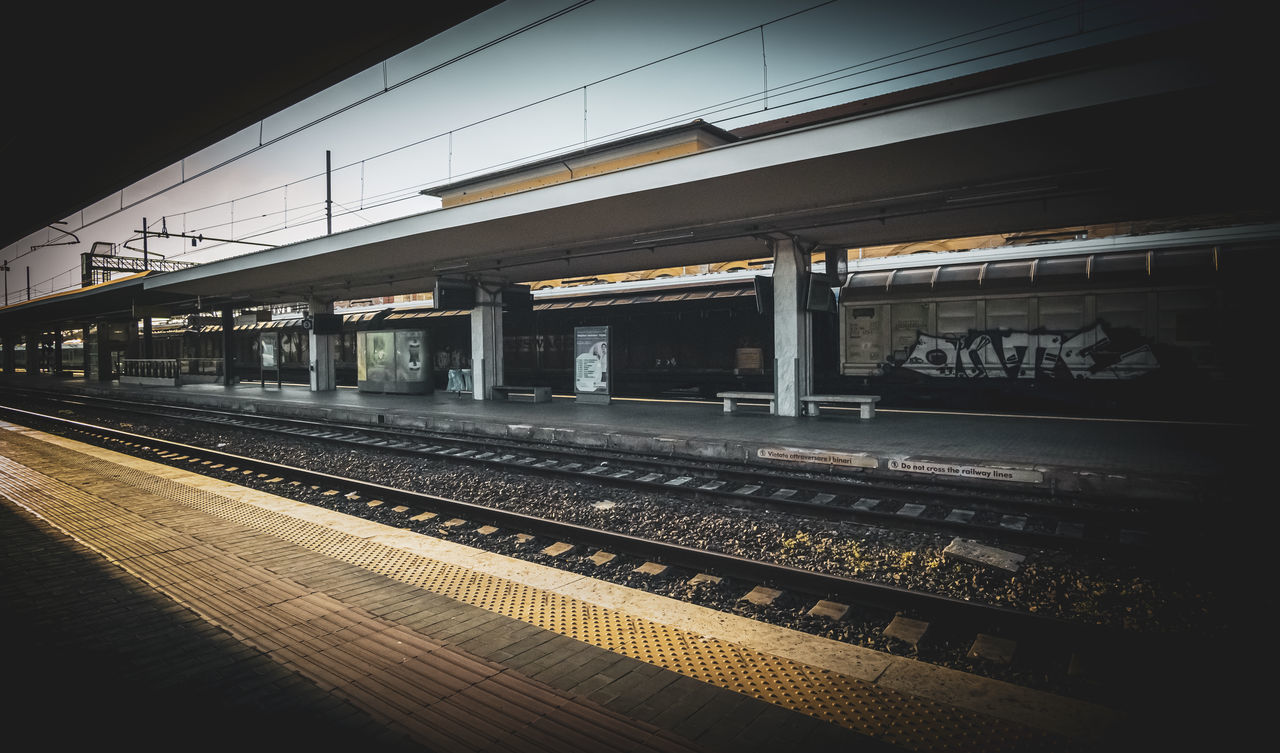 TRAIN AT RAILROAD STATION PLATFORM AGAINST SKY