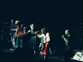 Group of people playing guitar at music concert