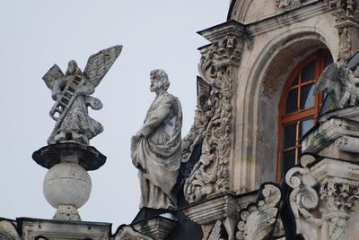 Low angle view of angel statue against sky