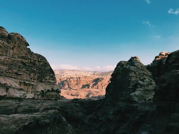 Rock formations on landscape against sky