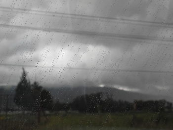 Full frame shot of wet glass window in rainy season