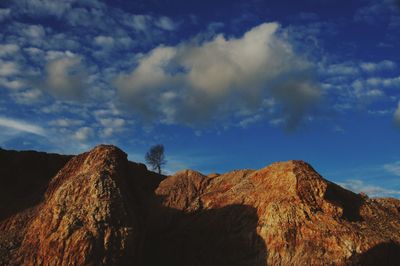 Low angle view of rock formations against sky