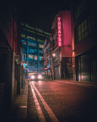 Illuminated city street at night