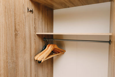 Close-up of clothes hanging on wooden wall at home