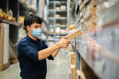 Man wearing mask working in warehouse