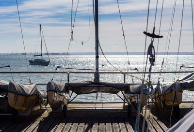 Boats sailing on sea against sky