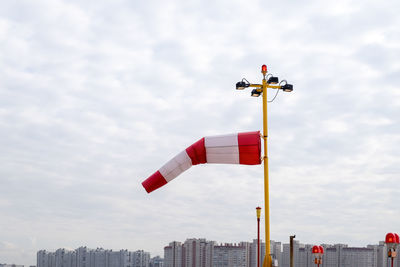 Wind index against cloudy sky and city skyline. selective focus.