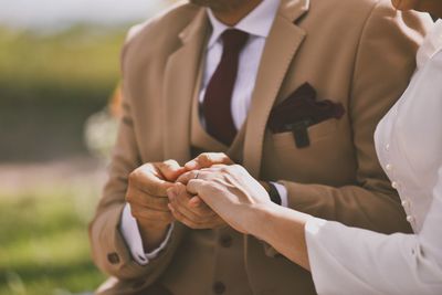 Low section of woman holding hands