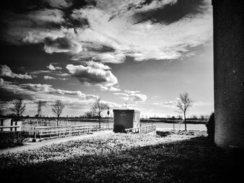 Rural landscape against cloudy sky