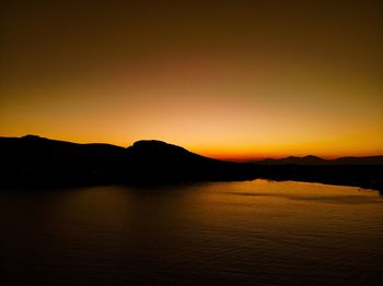 Scenic view of lake against romantic sky at sunset