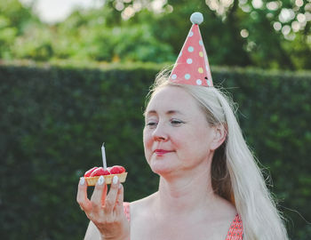 Woman celebrating birthday with cake and candles. birthday girl.