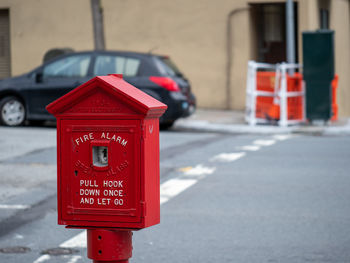 Red information sign on street in city