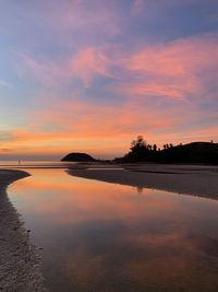 Scenic view of lake against romantic sky at sunset