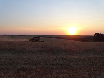 Scenic view of field against sky during sunset