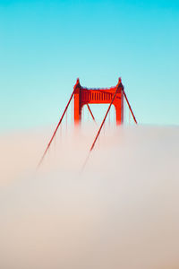 Golden gate bridge against clear blue sky during foggy weather