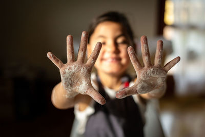 Close-up of child's hands dirty with flour