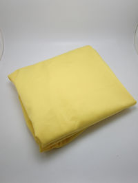 High angle view of yellow paper on white background