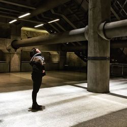 Full length of woman standing by railing