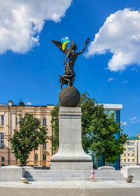 Low angle view of statue against blue sky