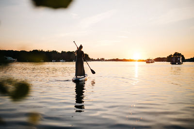 Silhouette of a women on a sup-board