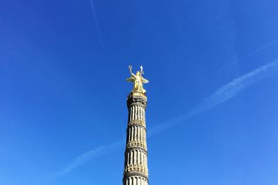 Low angle view of berlin victory tower against clear blue sky