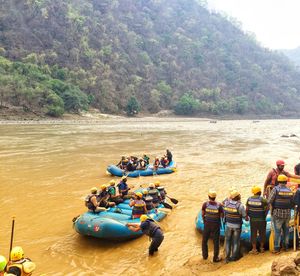 People river rafting by mountain