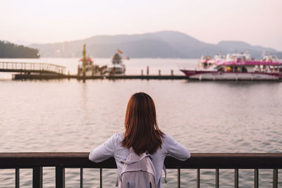 Rear view of woman looking at lake