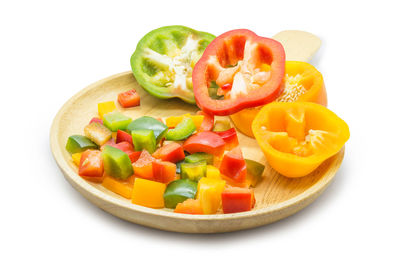 Close-up of fruits served in plate against white background