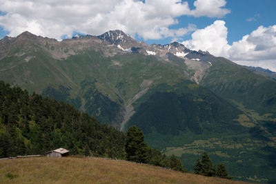 Scenic view of mountains against cloudy sky