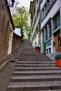 Low angle view of steps amidst buildings